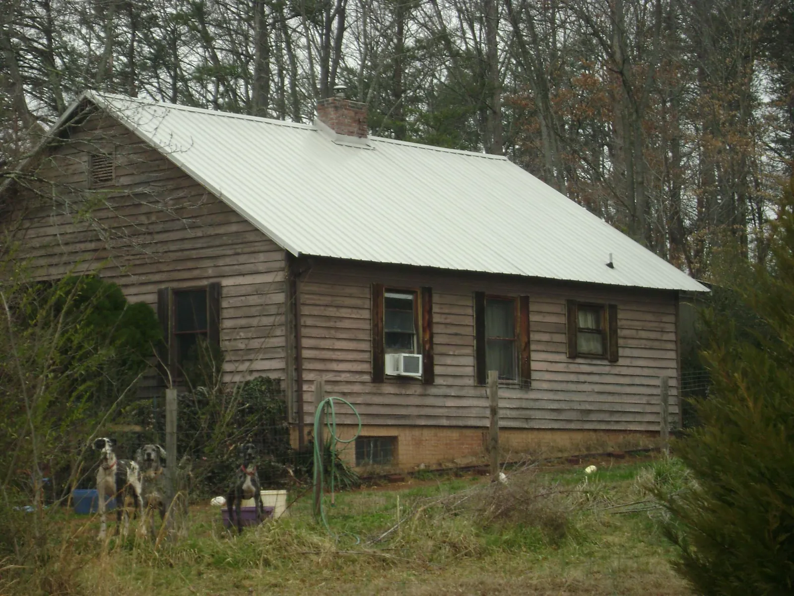 White metal roof on an old wood sided farmhouse, from a Metal Roof Installation job in Oslo